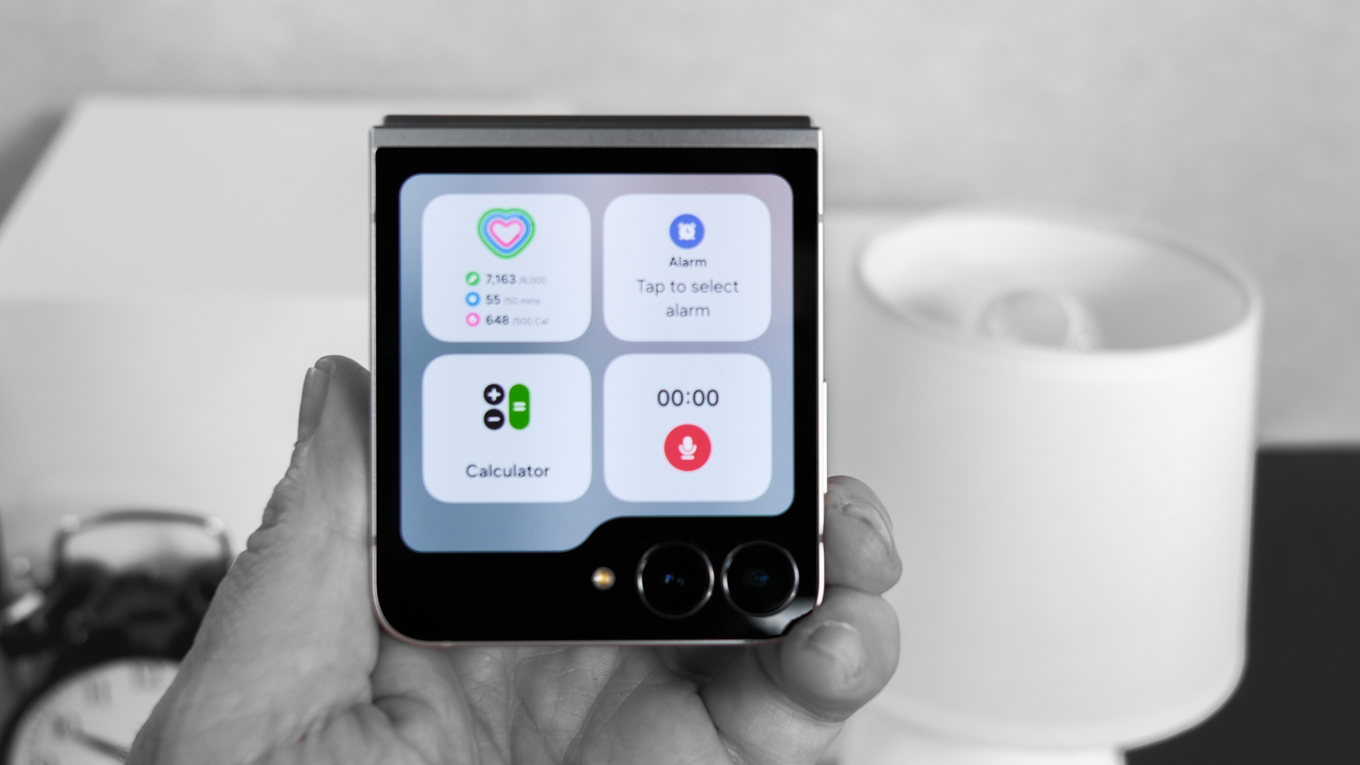 Samsung Galaxy Z Flip 7 FE closed with widgets showing on the cover display