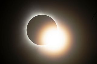 The eclipse is reaching totality over the Indianapolis Motor Speedway in Indianapolis, Indiana, USA, on April 8, 2024