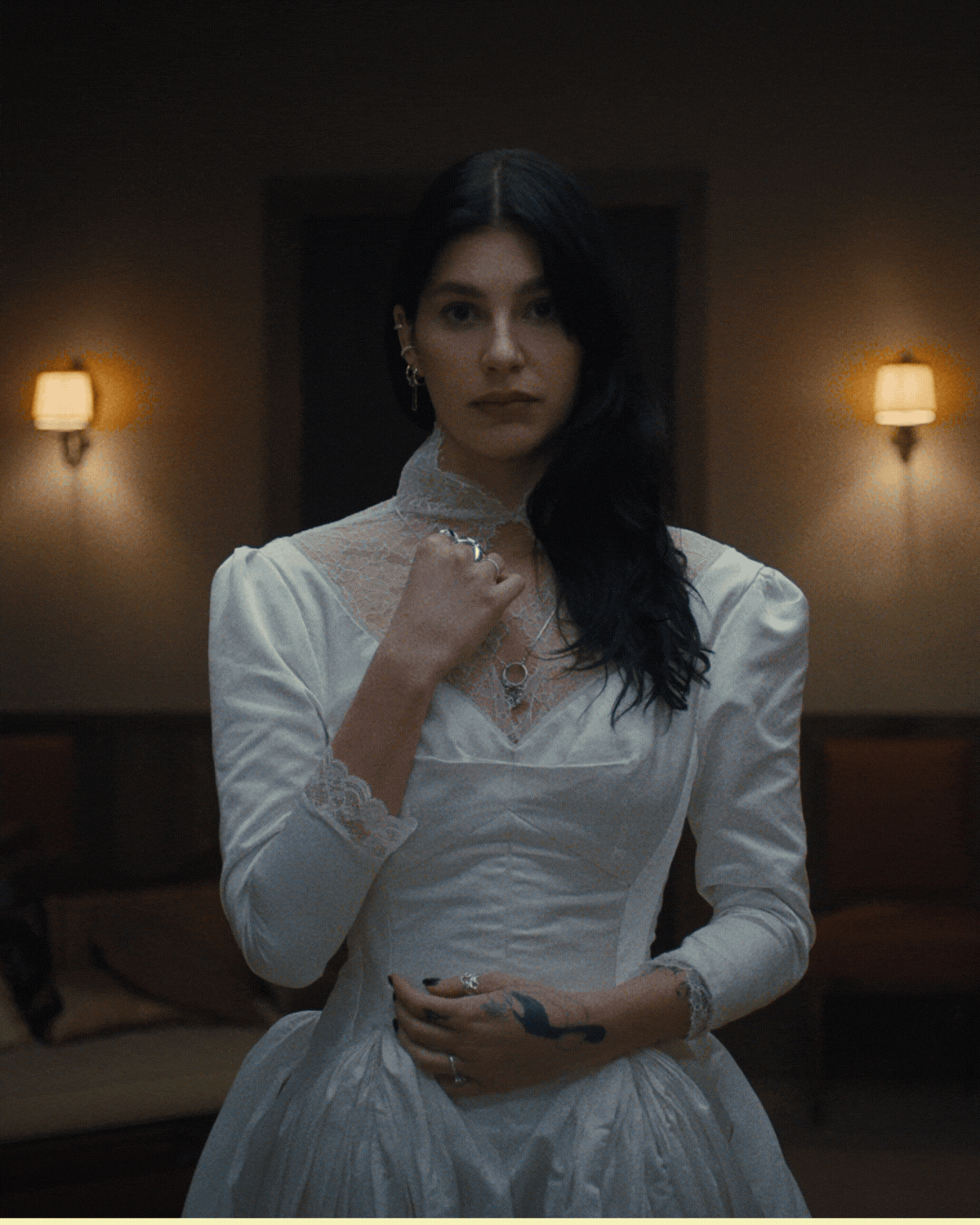 Rotating GIF of production stills from Netflix's Something Very Bad is Going to Happen. It's four images of dark, mid-century-style cabin interiors with low lamp lighting.