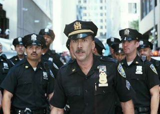 Nicolas Cage (center) plays Port Authority police officer John McLoughin, while Michael Pena (left, background) plays officer Will Jimeno.