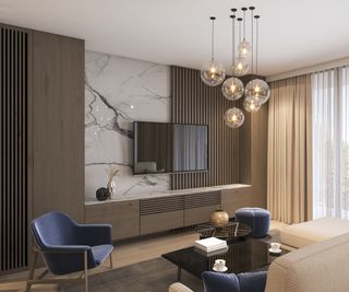 cluster of glass globe pendant lighting in living room with blue chair, marble and wood media wall, floor to ceiling cream curtains and wooden floor