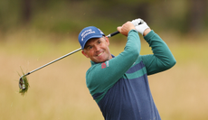 Padraig Harrington hits an iron shot from the rough