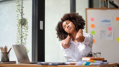 Desk exercise: A woman stretching at her desk