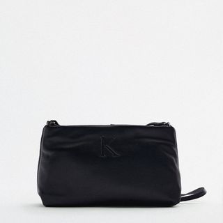 black leather cross body bag embroidered with the letter K