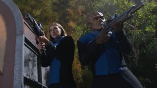 Cmdr. Grayson (Adrianne Palicki) and Lt. Cmdr. Bortus (Peter Macon) ready themselves to defend the exiled colony of Moclan women.