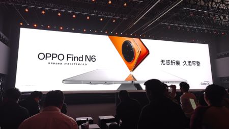 A large display in an auditorium displaying a teaser for the launch of the Oppo Find N6