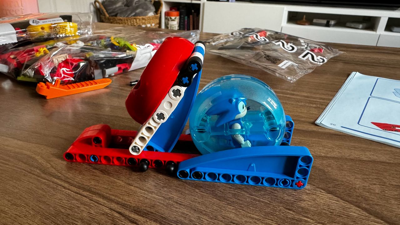 Lego Sonic vs. Dr. Eggman's Death Egg Robot pieces on a wooden coffee table