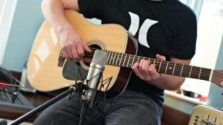 Best acoustic guitar microphones: Playing an acoustic guitar