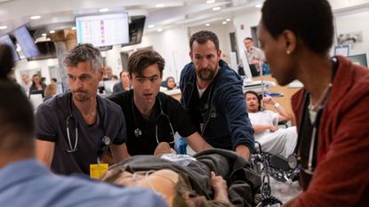 ER doctors, including Dr. Michael "Robby" Rabinavitch (Noah Wyle) attend to a patient in The Pitt