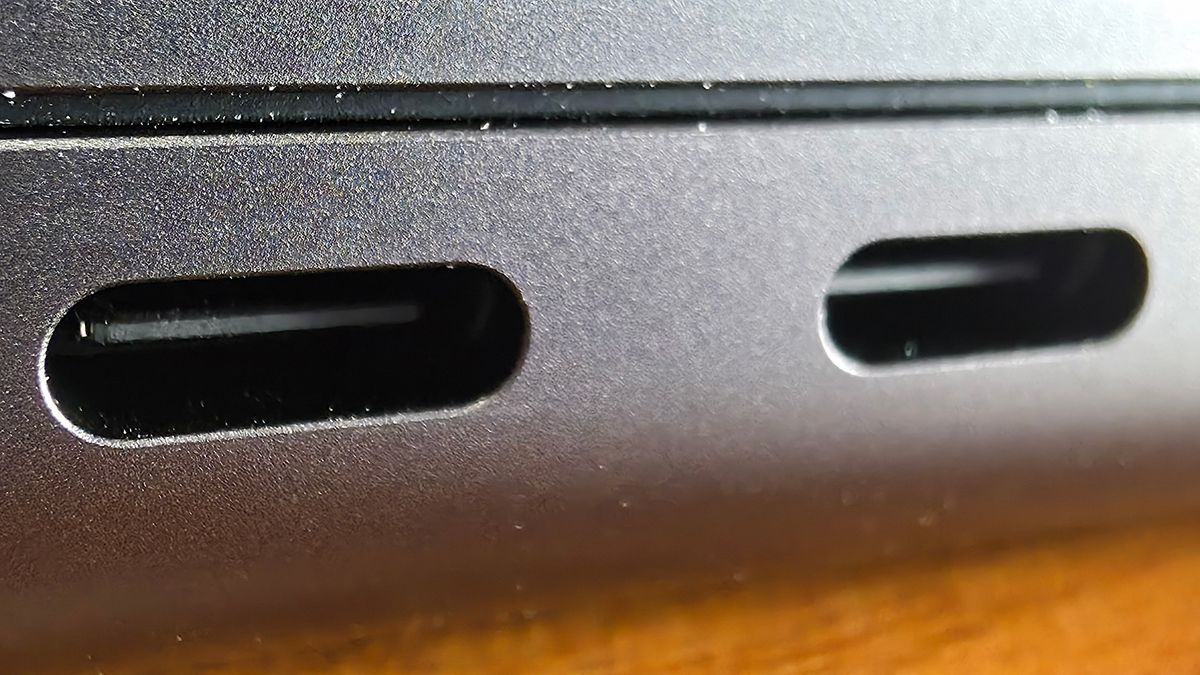 Macro photo of the Thunderbolt 4 ports on a 14-inch MacBook Pro M4.