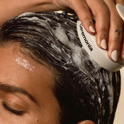 woman using scalp massager