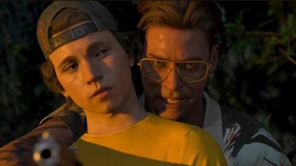 A tense situation unfolds as armed man peers over younger man's shoulder
