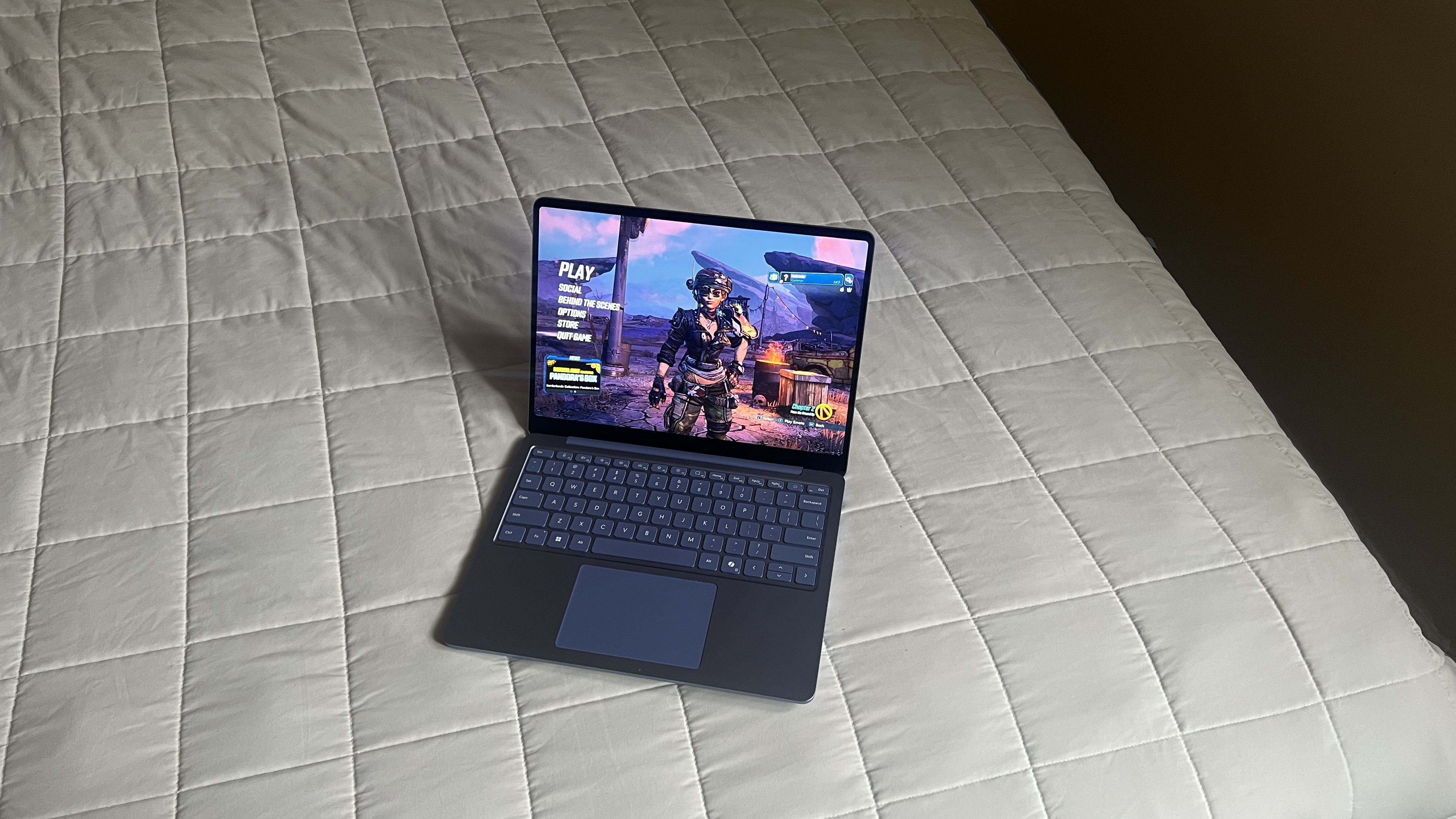 A Microsoft Surface Laptop 13-inch on a bed