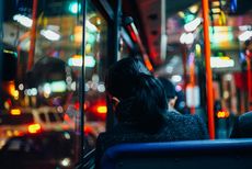 woman sitting alone on a bus