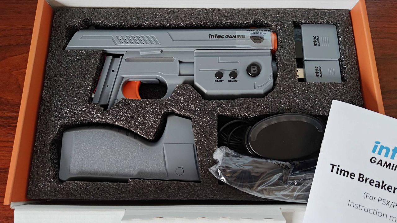 Intec Time Breaker Lightgun in foam box insert with barrel and magazine separated next to PS1 and PS2 dongles and IR sensor.
