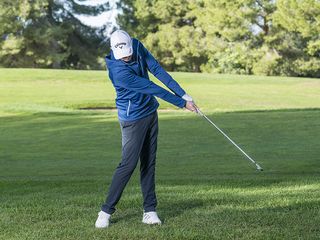 Golf Monthly Top 50 Coach Ben Emerson holding the clubface open through impact to hit a left to right golf shot