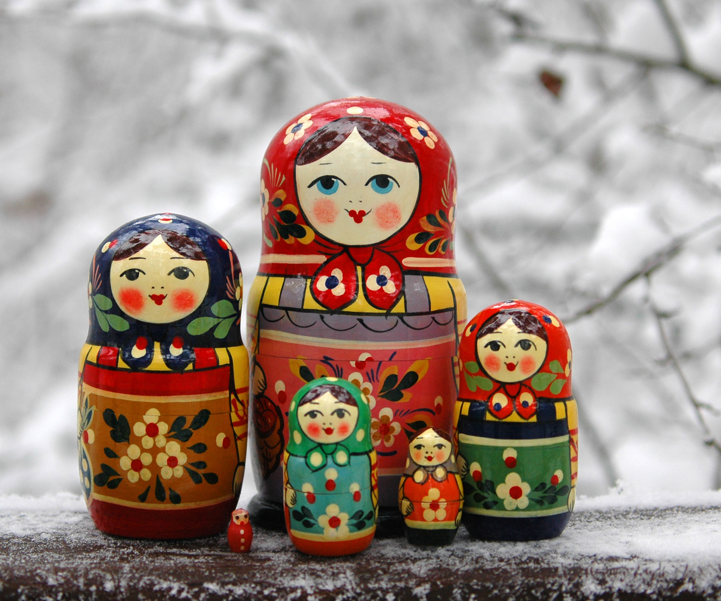 Russian dolls in snowy scene in garden