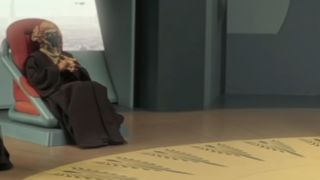 Plo Koon sitting in a chair in the Star Wars universe.