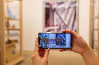 augmented reality element seen through phone at the herzog and de meuron exhibition in London