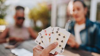 close up of cards with friends in the background