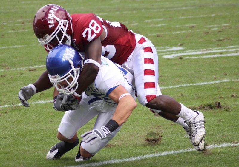 A football player tackles another player during a game.