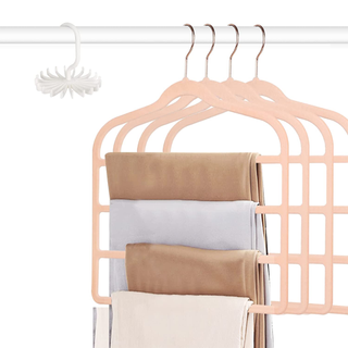 A set of 4 blush velvet hangers with tiers for hanging pants