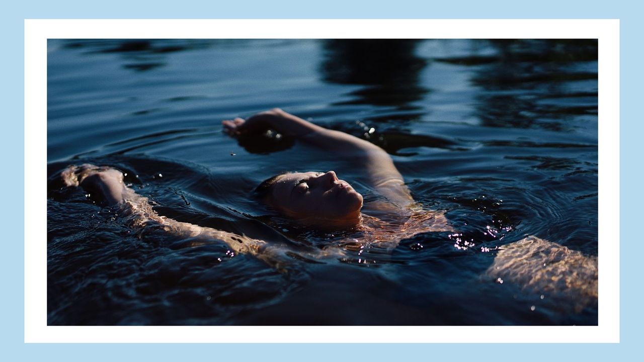 woman in black bikini floating in the ocean