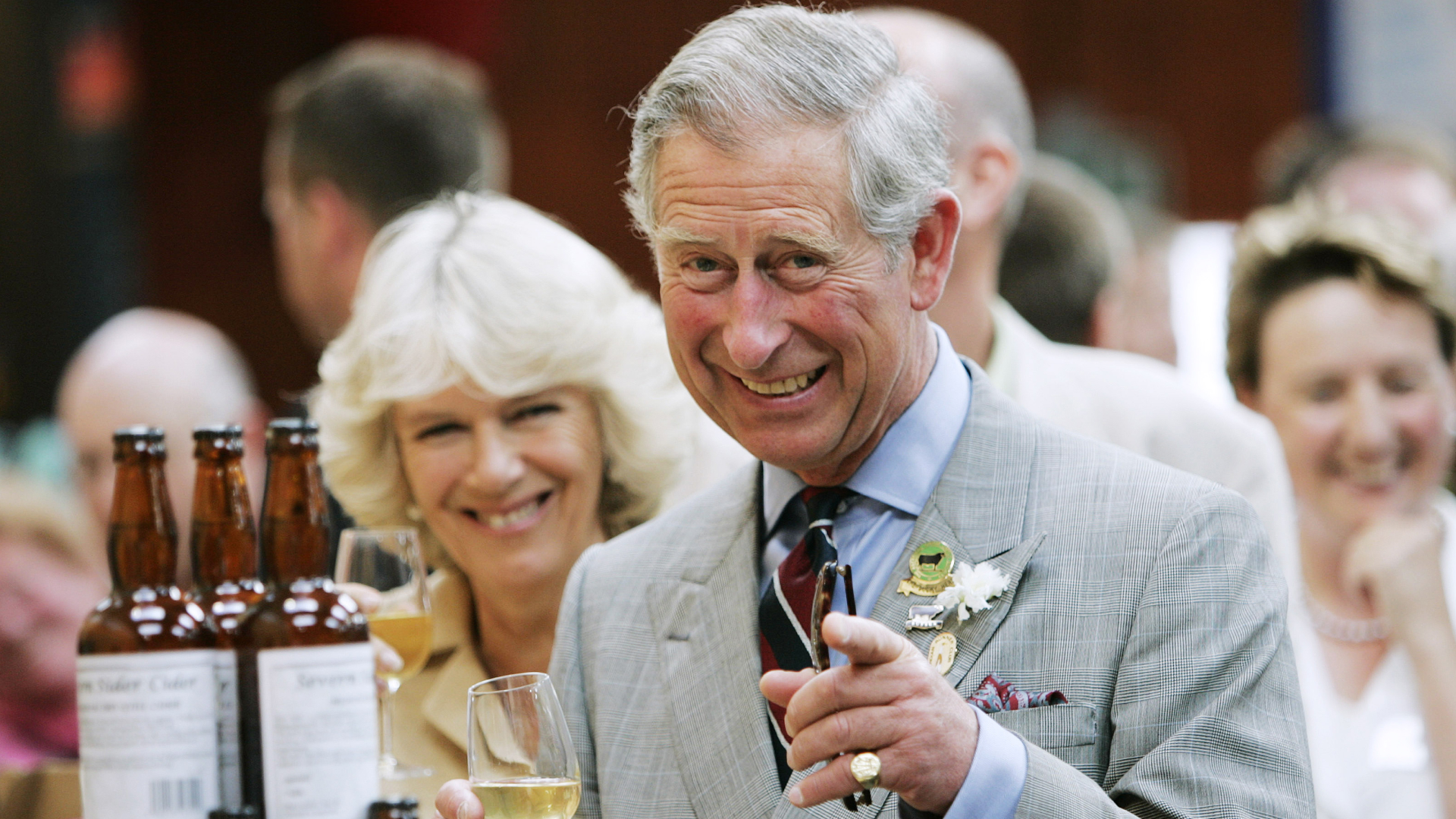 Queen Camilla and King Charles smile while sampling some wine and beers