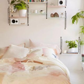bed and planting in an urban outfitters bedroom