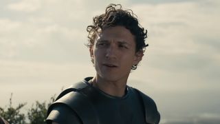 Tom Holland on a beach in the Odyssey trailer.