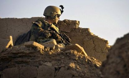 A U.S. Special Operations soldier watches over a rooftop in Kandahar province, Afghanistan: With bin Laden dead, critics of the Afghanistan war say it's time to pull our troops out.
