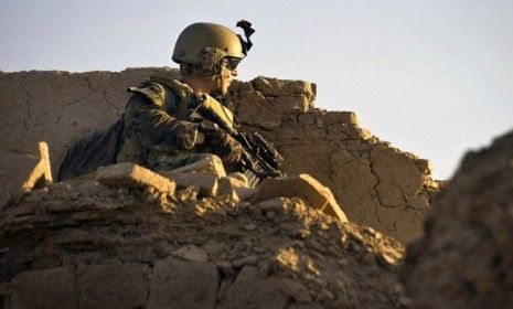 A U.S. Special Operations soldier watches over a rooftop in Kandahar province, Afghanistan: With bin Laden dead, critics of the Afghanistan war say it&amp;#039;s time to pull our troops out.