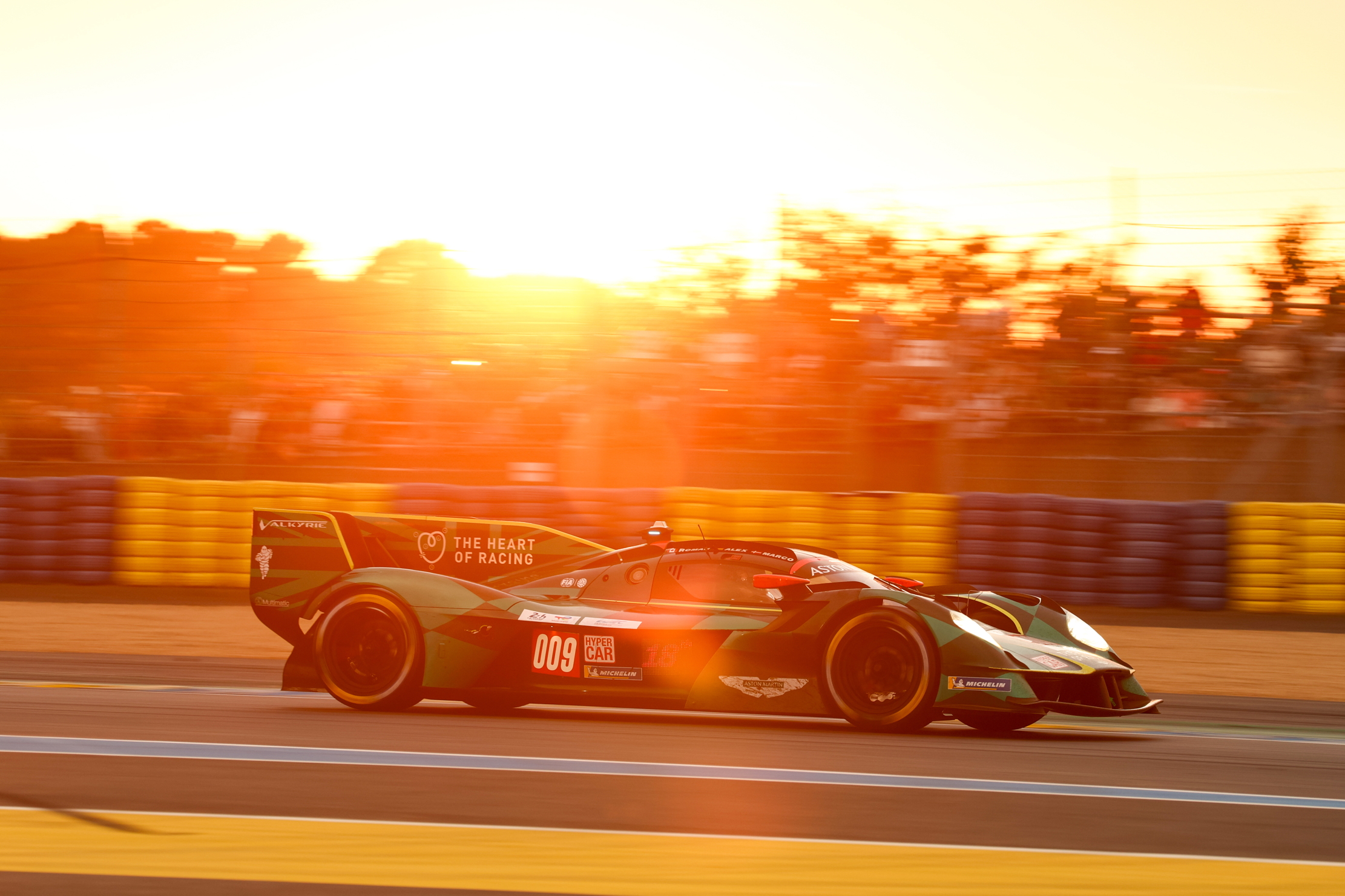 The Aston Martin Valkyrie 009 corners during the sunset at Le Mans 2025