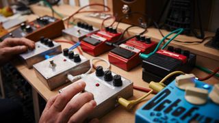 A man testing a variety of effects pedals