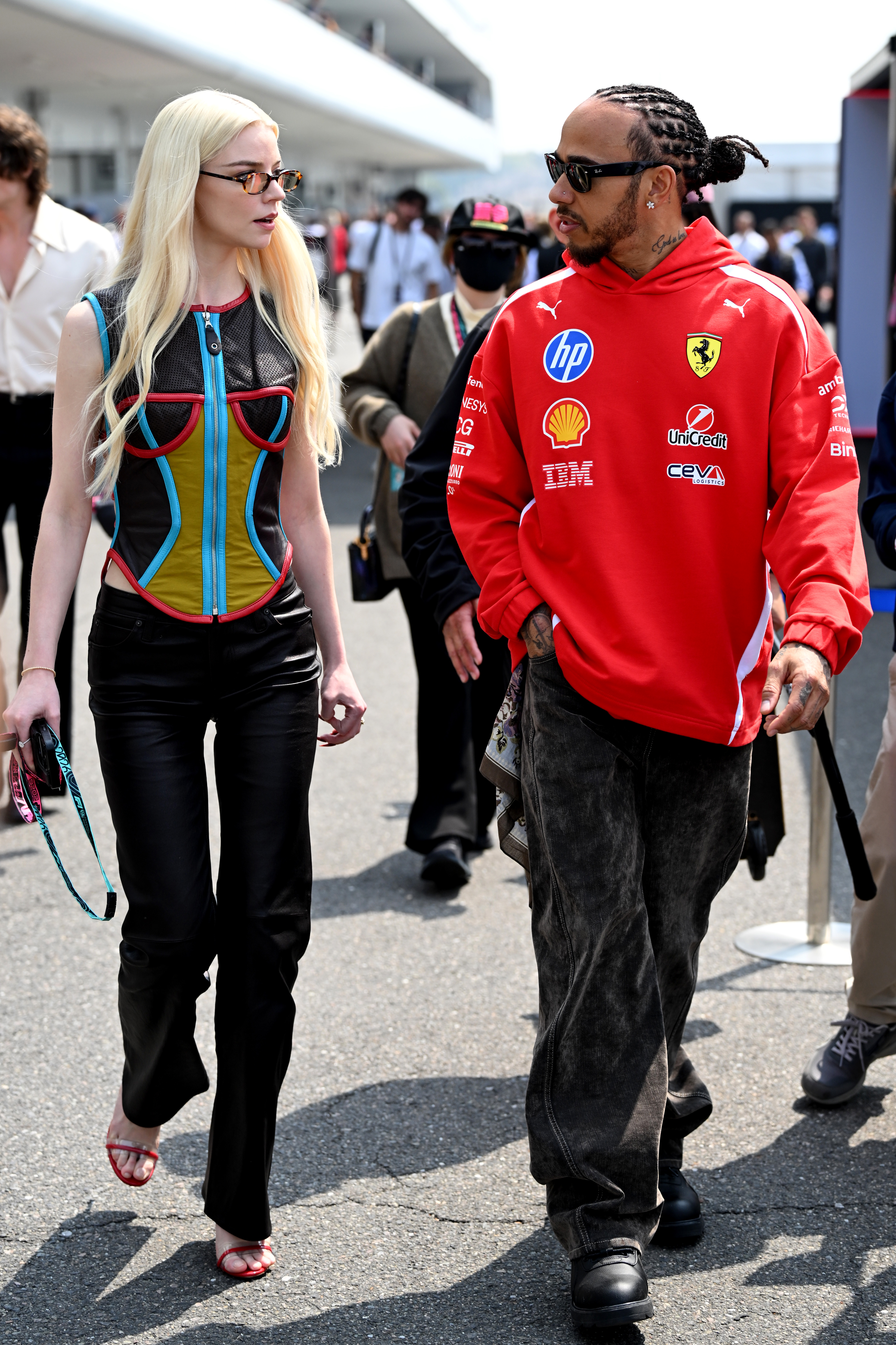 SUZUKA, JAPAN - MARCH 29: Lewis Hamilton of Great Britain and Scuderia Ferrari and Anya Taylor-Joy walk in the Paddock prior to the F1 Grand Prix of Japan at Suzuka Circuit on March 29, 2026 in Suzuka, Japan.