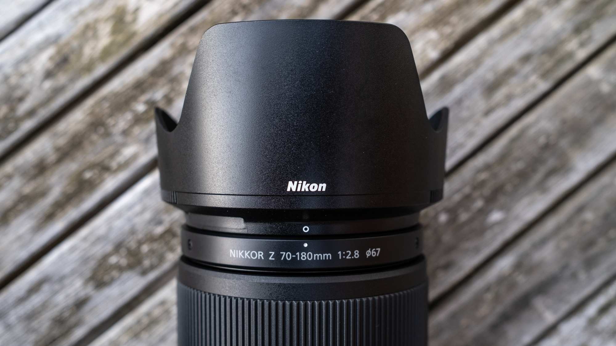 Nikkor Z 70-180mm f/2.8 attached to a Nikon Z 7II on a wooden outdoor table