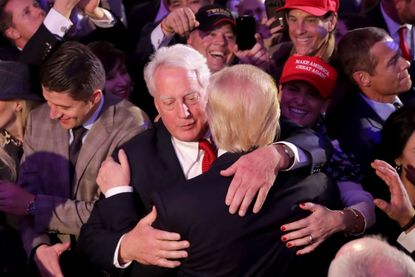 Republican president-elect Donald Trump (R) hugs his brother Robert Trump after delivering his acceptance speech at the New York Hilton Midtown in the early morning hours of November 9, 2016 