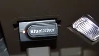 Best OBD-II scanners: BlueDriver Pro Scan Tool underneath a car's dashboard.