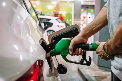 Person refuelling vehicle on self service gas station