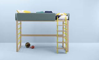 Children's wooden bunk bed with yellow ladder and blue and yellow cushions