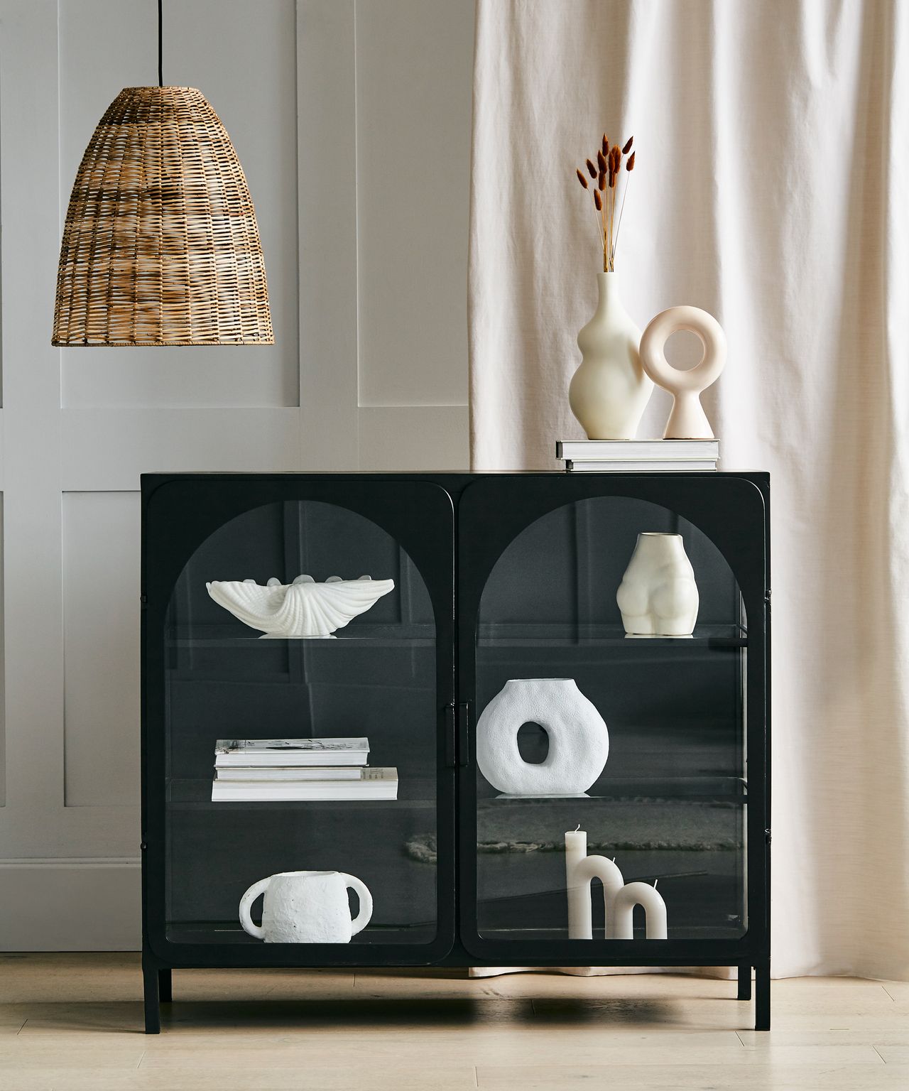 curves trend with arch design storage display cabinet and curved accessories in mono palette