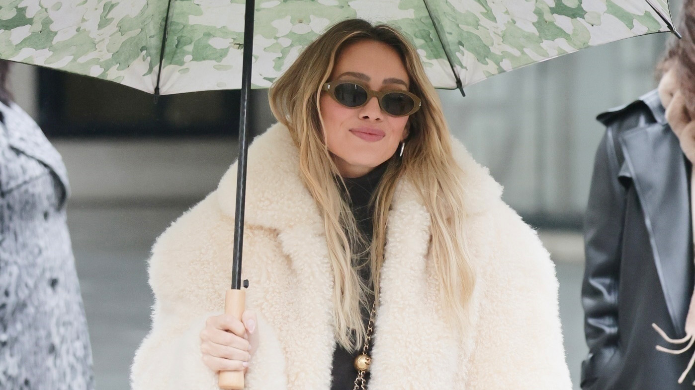 Hilary Duff wearing a cream fur coat in London