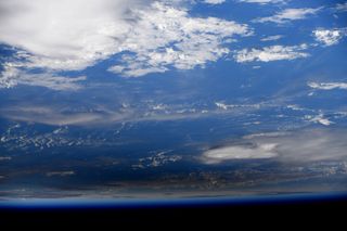 NASA astronaut Jessica Meir captured these photos of the Dec. 26, 2019 annular solar eclipse from the International Space Station. They show the moon's shadow moving across the surface of the Earth.