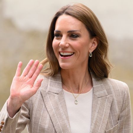 Princess Kate wearing a tan blazer and waving