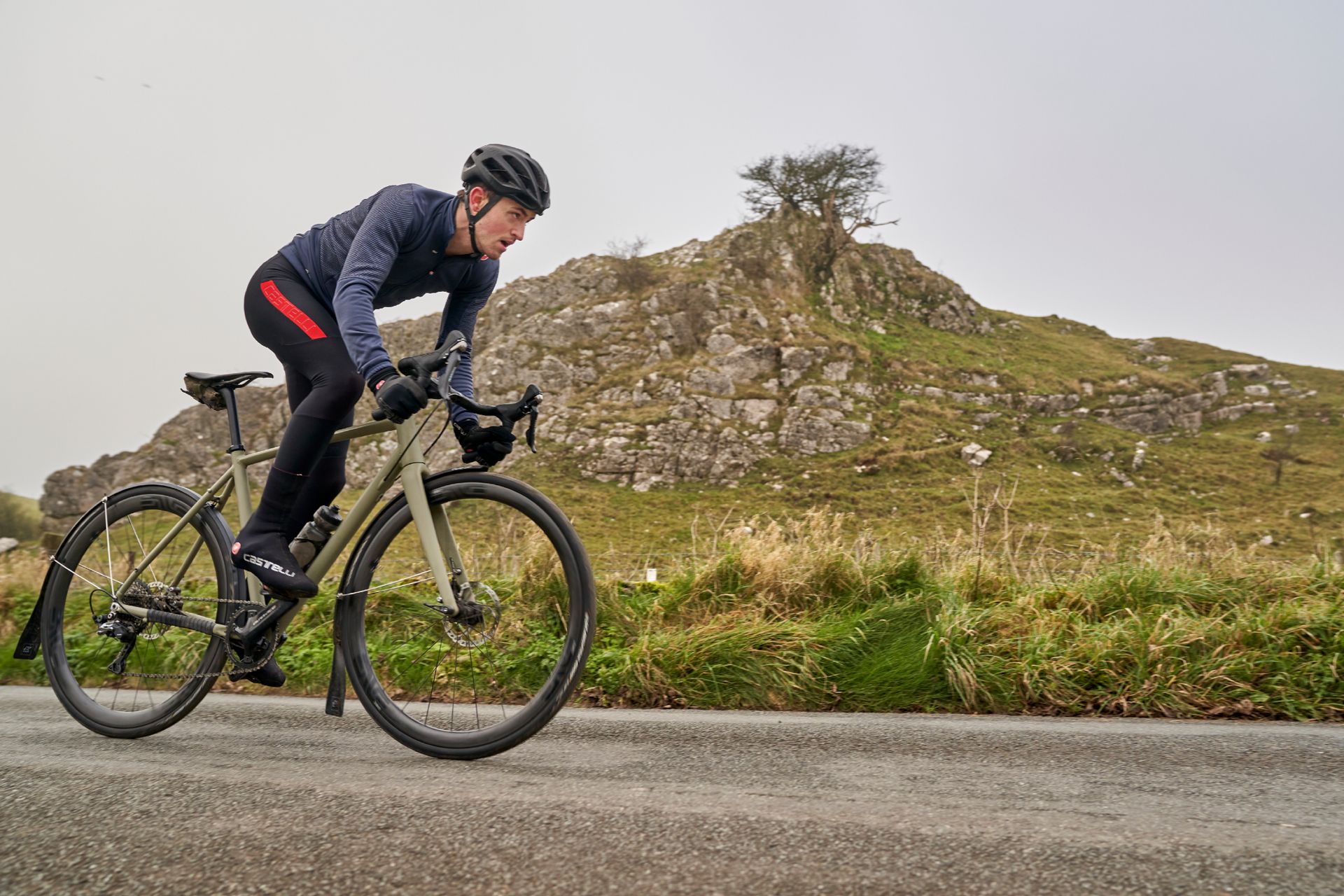 Image shows a person cycling during the winter