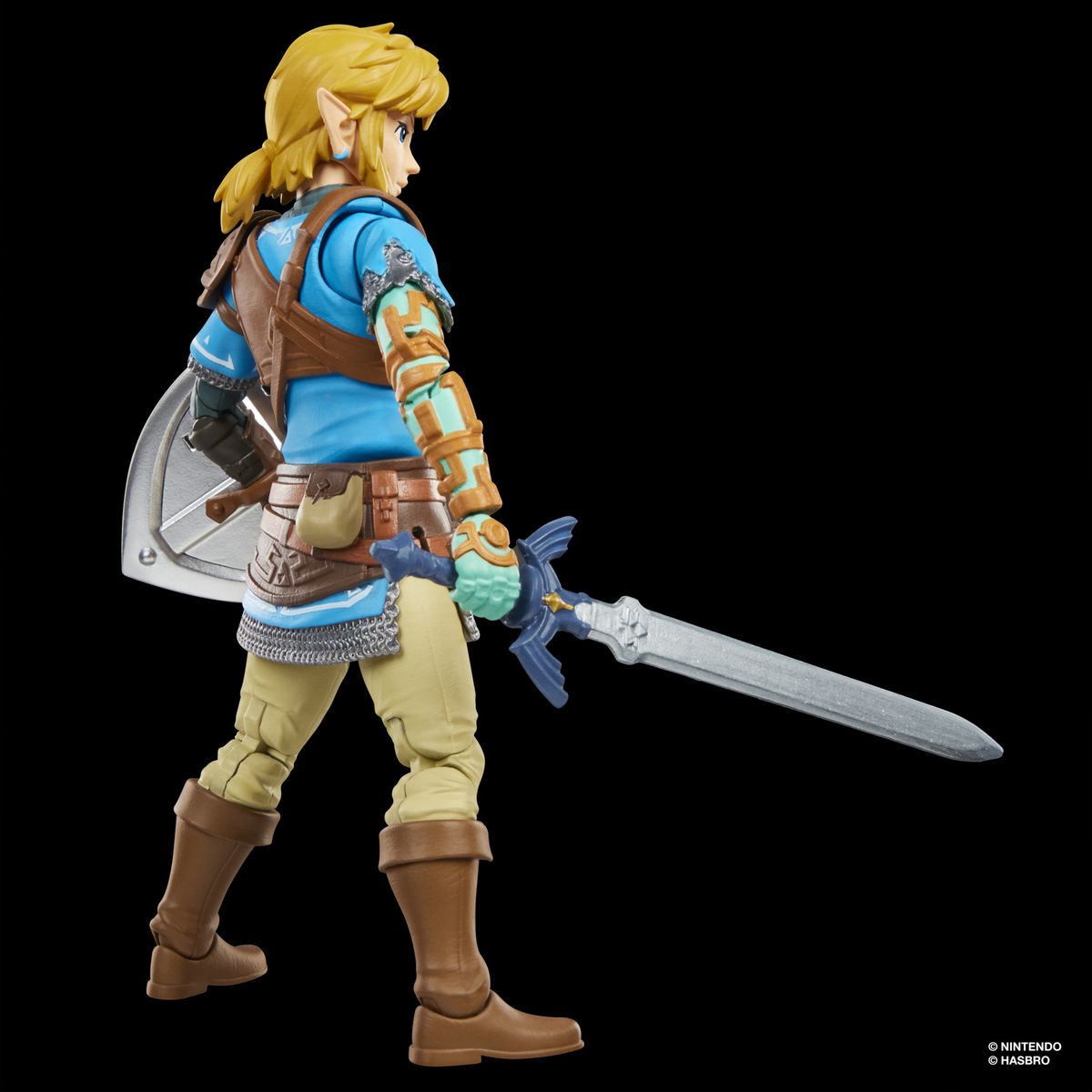 An action figure of Link from Tears of the Kingdom stands against a dark background