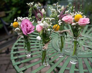 small posies of garden flowers on garden table