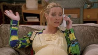 Phoebe on the phone with her hand up in Friends