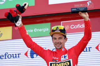 Team Jumbos Slovenian rider Primoz Roglic celebrates on the podium wearing the overall leaders red jersey after the 6th stage of the 2021 La Vuelta cycling tour of Spain a 1583 km race from Requena to Cullera on August 19 2021 Photo by JOSE JORDAN AFP Photo by JOSE JORDANAFP via Getty Images