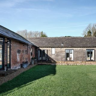 Courtyard garden lawn in winter surrounded by Georgian cowshed and stable block renovation